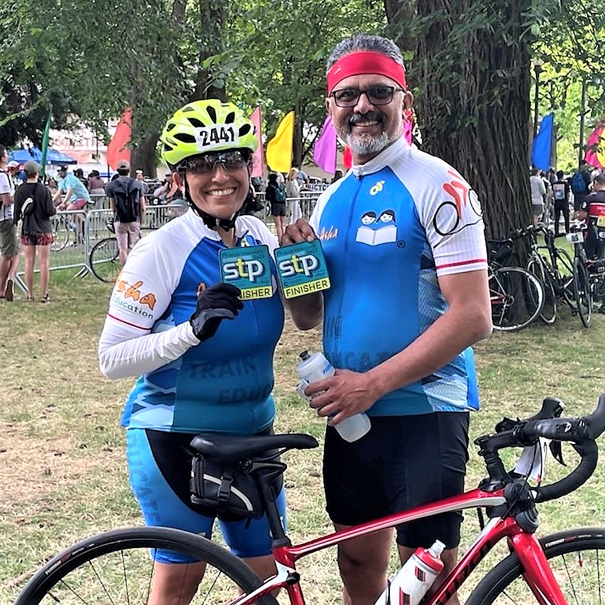 Seema and Ashay Chaudhary with STP Finishers badges